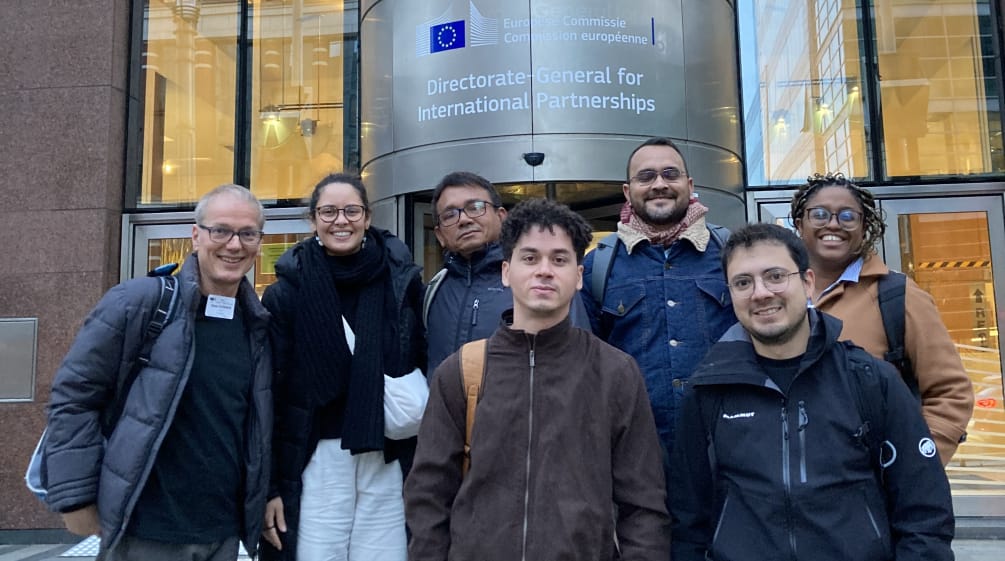 Foto di gruppo di 7 persone davanti all'ingresso di un edificio della Commissione europea a Bruxelles.